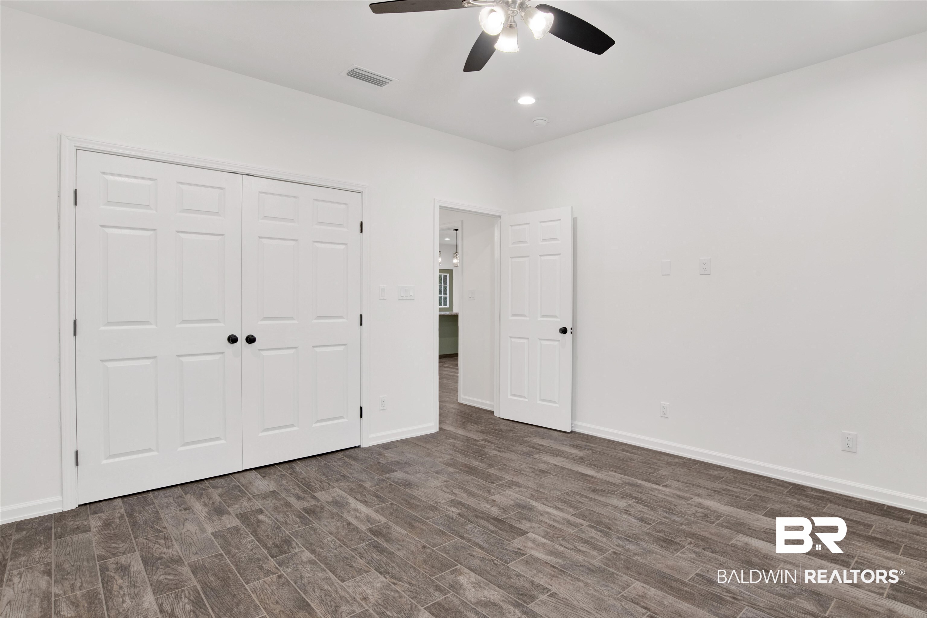 10871 Somerset Road Grand Bay, AL 36541 - Photo 19 of 31 Unfurnished bedroom featuring ceiling fan, dark wood-type flooring, and a closet