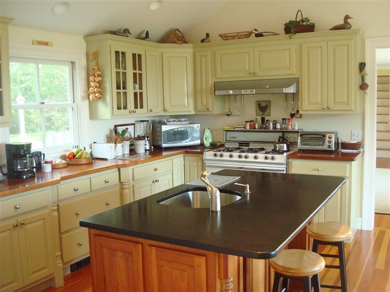 74 Sears Point Road Chatham, MA 02633 - Photo 13 of 16 a kitchen with stainless steel appliances granite countertop a sink a stove and cabinets