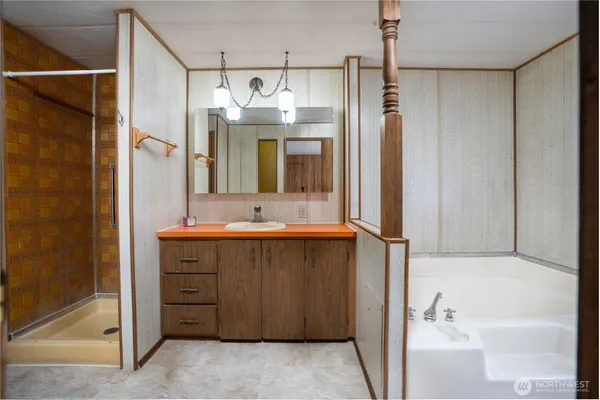 a bathroom with a double vanity sink mirror and shower