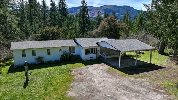 a aerial view of a house next to a yard