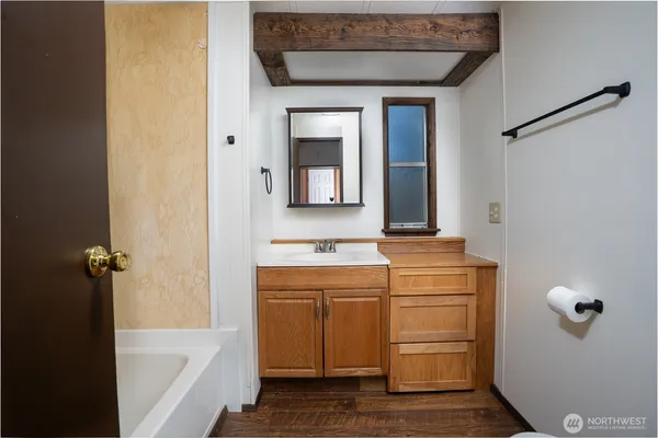 a bathroom with a sink a mirror and a bathtub