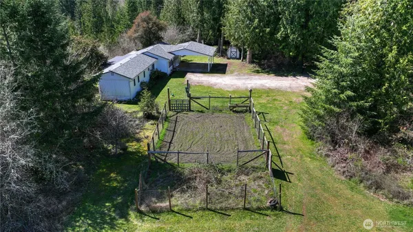 a aerial view of a house with large trees