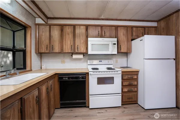 a kitchen with a stove cabinets and refrigerator