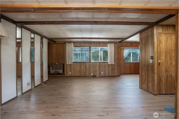 a view of an entryway with wooden floor and door