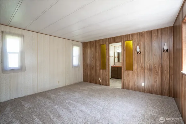 an empty room with windows and closet