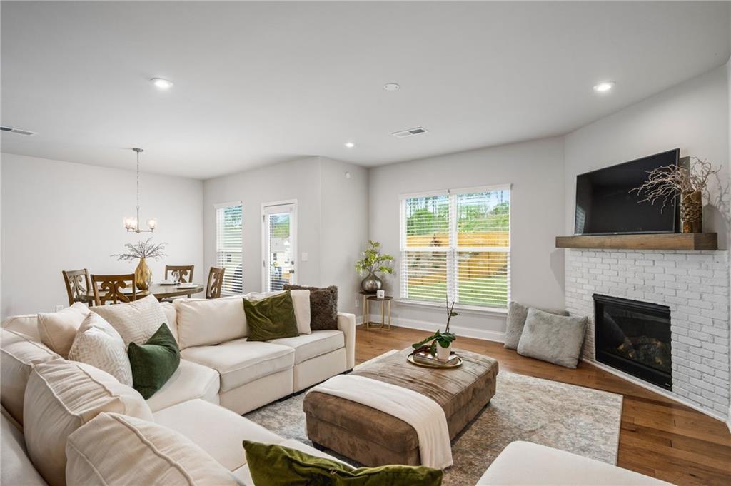 a living room with furniture fireplace and window
