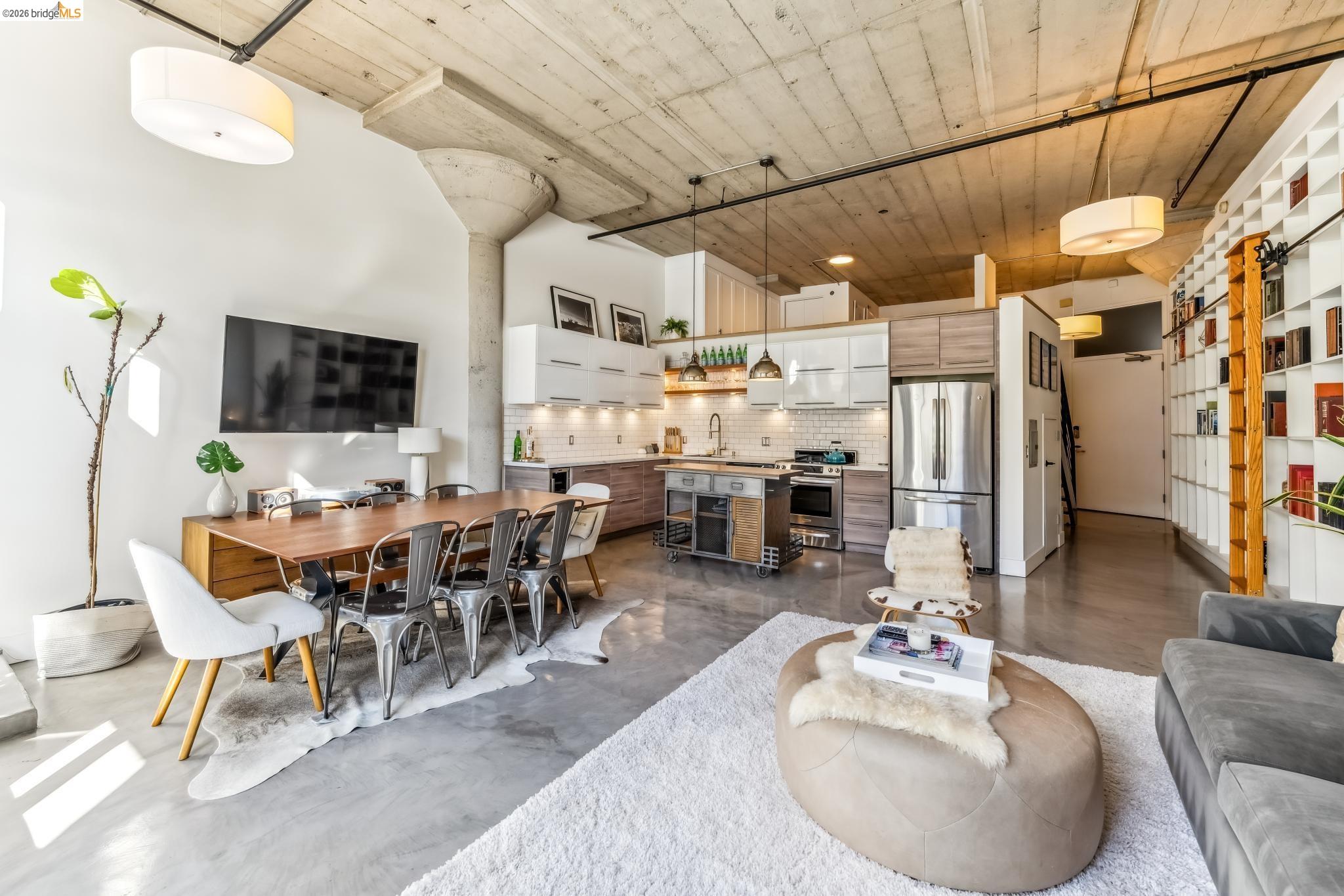 255 3rd Street, Unit 206 Oakland, CA 94607 - Photo 4 of 7 Open-concept living space with concrete flooring, exposed concrete ceiling, and industrial-style ductwork
