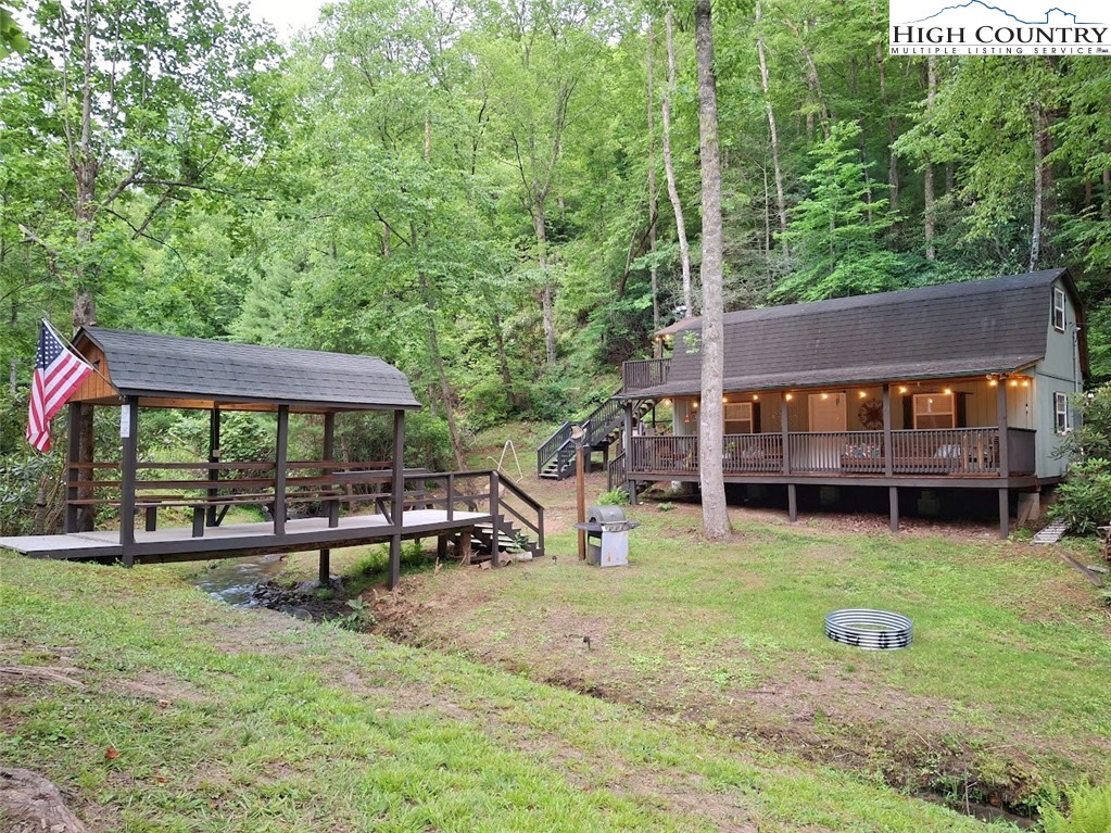 a view of a house with backyard porch and sitting area