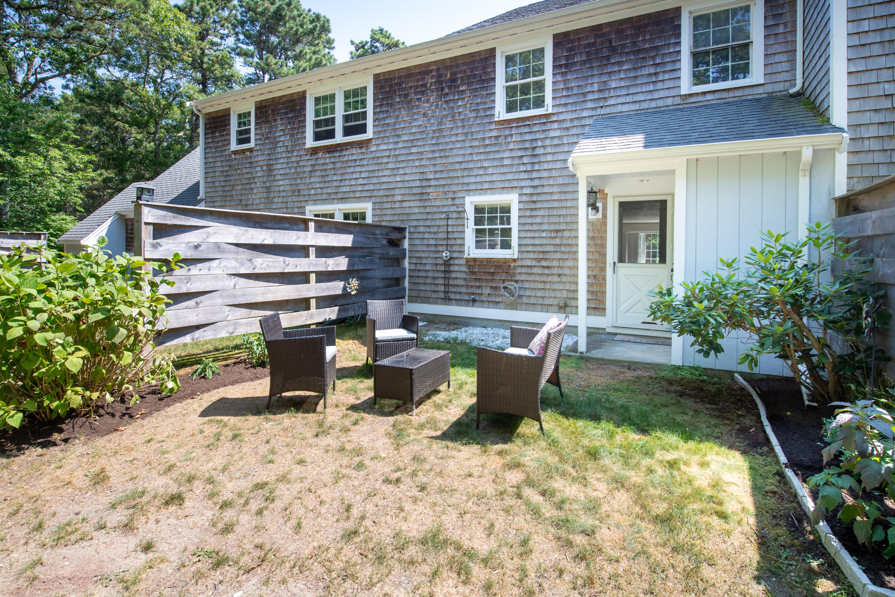 248 Camp Street, Unit M5 West Yarmouth, MA 02673 - Photo 8 of 12 a view of backyard of house with seating space