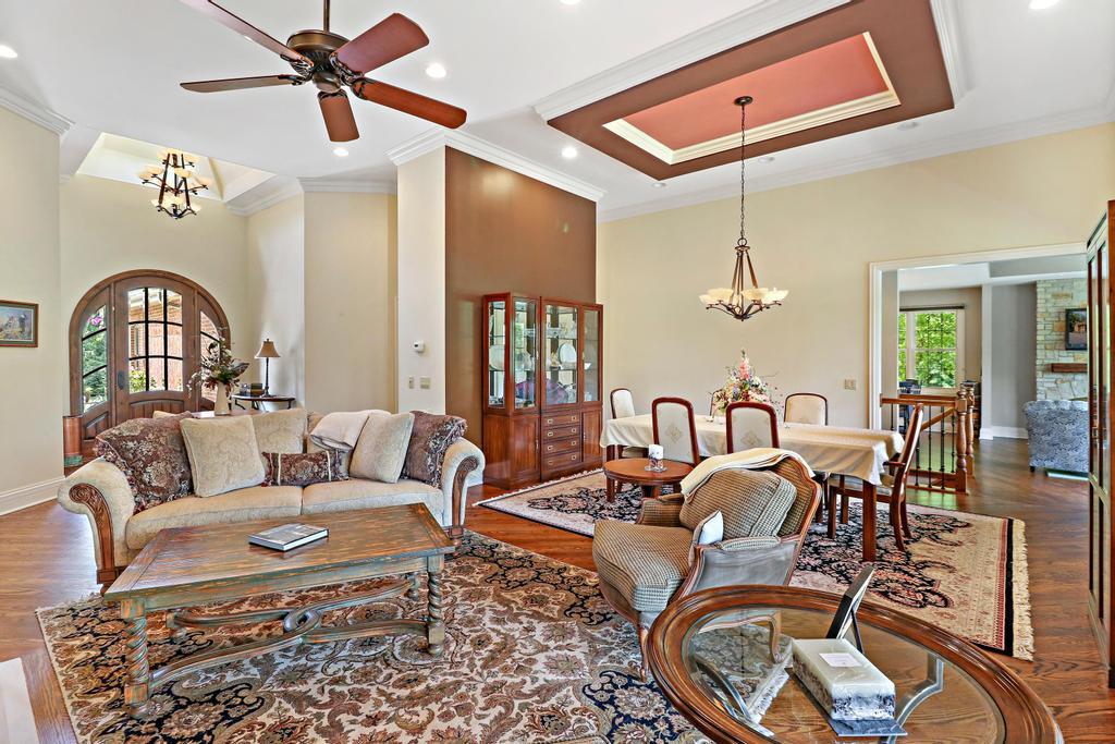 385 Spring Creek Road Barrington Hills, IL 60010 - Photo 12 of 53 a living room with furniture a ceiling fan and a rug