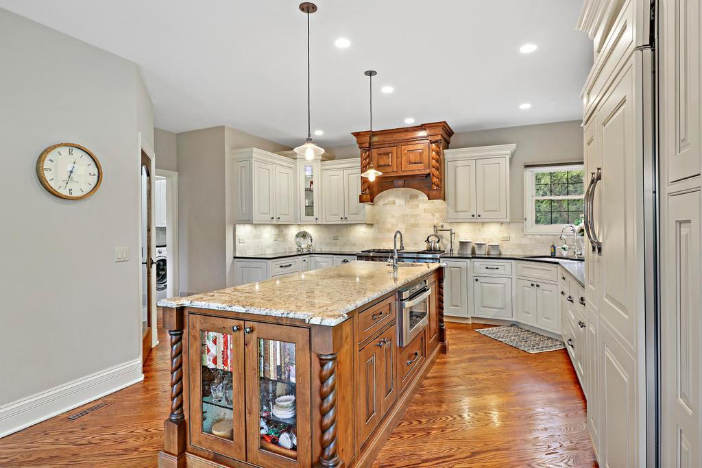 385 Spring Creek Road Barrington Hills, IL 60010 - Photo 17 of 53 a kitchen with a stove a refrigerator and a sink