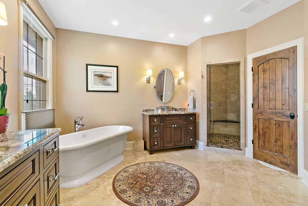 385 Spring Creek Road Barrington Hills, IL 60010 - Photo 28 of 53 a spacious bathroom with a tub sink and mirror