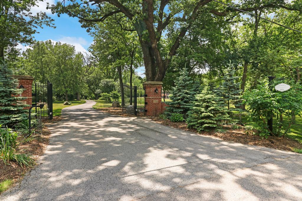 385 Spring Creek Road Barrington Hills, IL 60010 - Photo 3 of 53 a view of a street with a trees