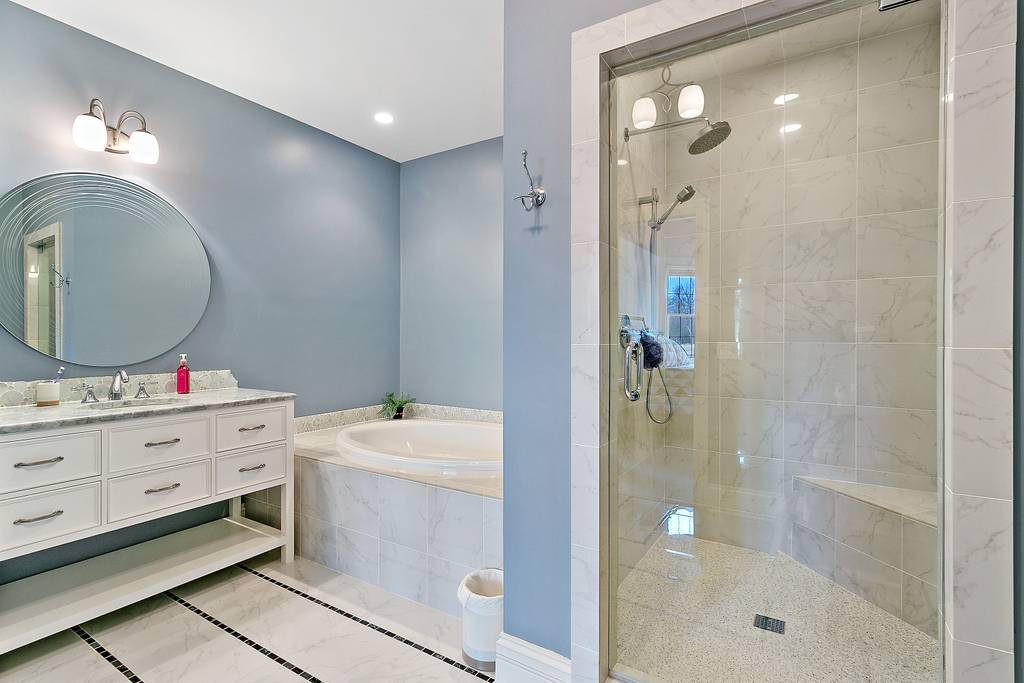 385 Spring Creek Road Barrington Hills, IL 60010 - Photo 33 of 53 a bathroom with a sink mirror and shower