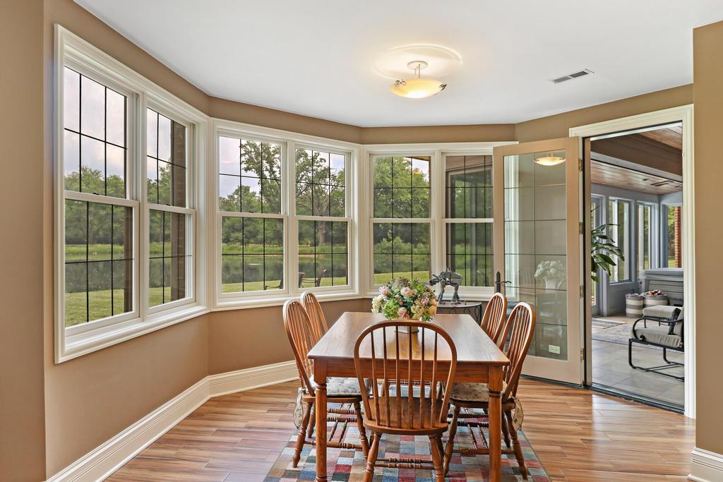 385 Spring Creek Road Barrington Hills, IL 60010 - Photo 38 of 53 a view of a dining room with furniture window and wooden floor