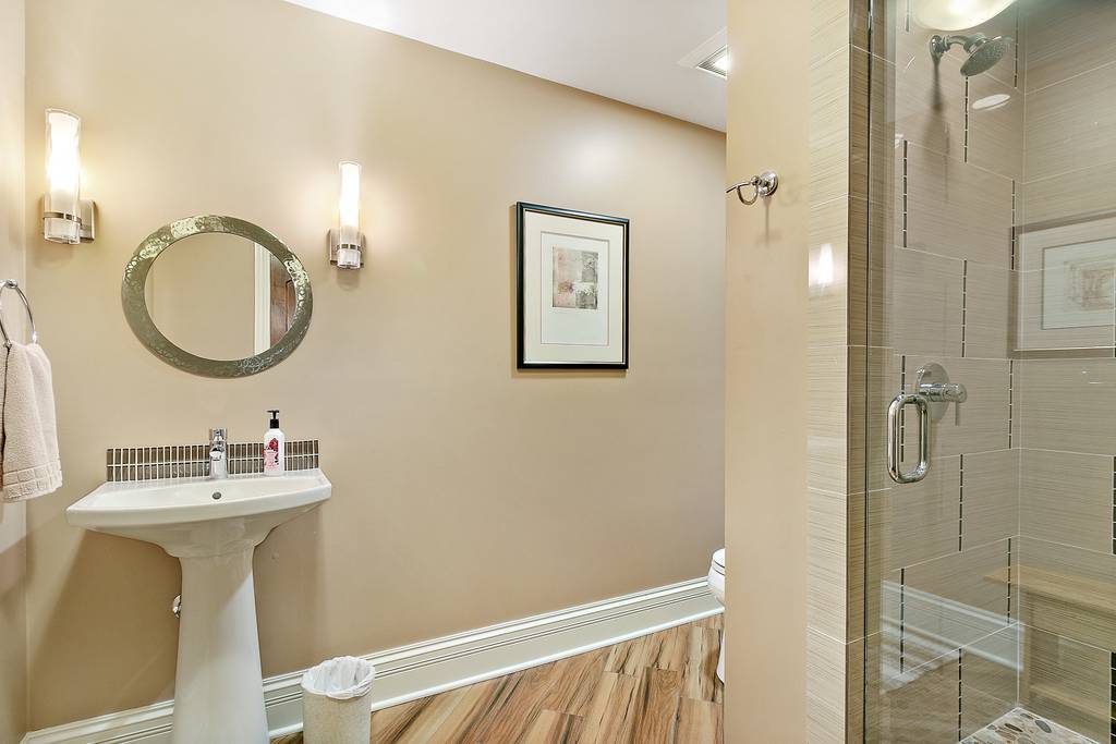 385 Spring Creek Road Barrington Hills, IL 60010 - Photo 43 of 53 a bathroom with a sink mirror and shower