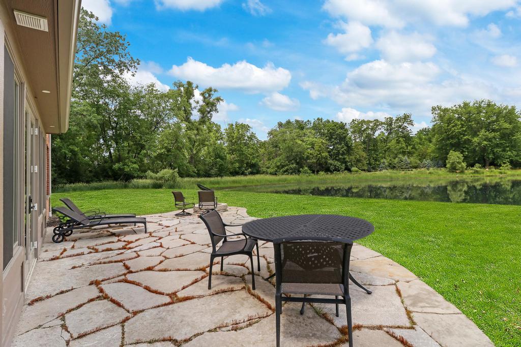 385 Spring Creek Road Barrington Hills, IL 60010 - Photo 49 of 53 a view of a table and chairs in backyard of the house