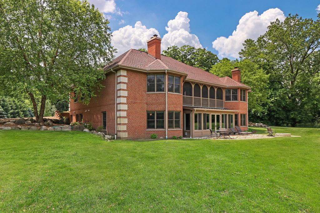 385 Spring Creek Road Barrington Hills, IL 60010 - Photo 50 of 53 a front view of a house with a yard