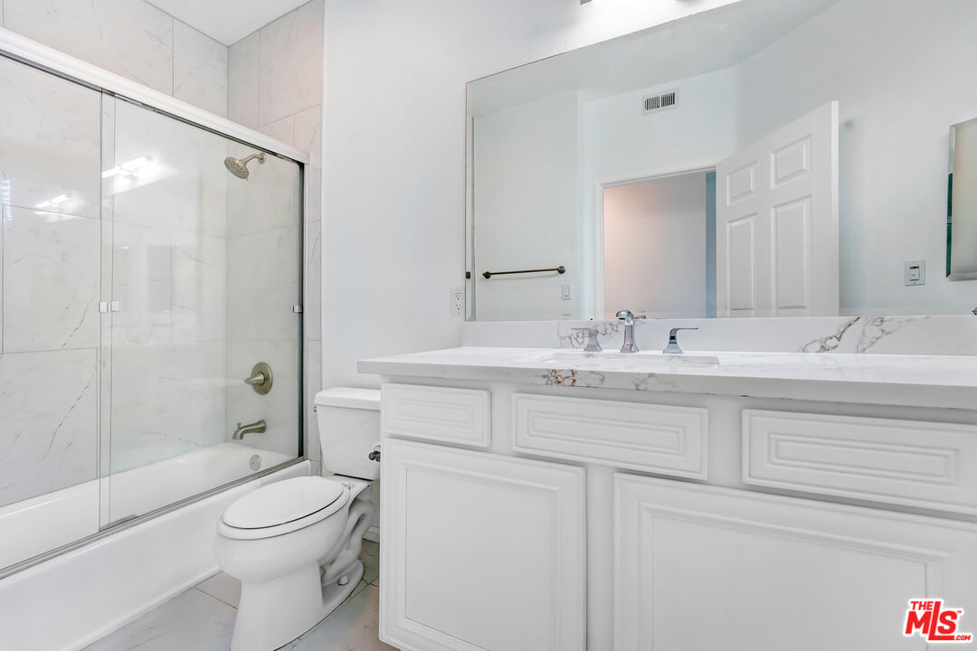 5430 Bellingham Avenue, Unit 306 Valley Village, CA 91607 - Photo 13 of 23 a bathroom with a sink a toilet and shower