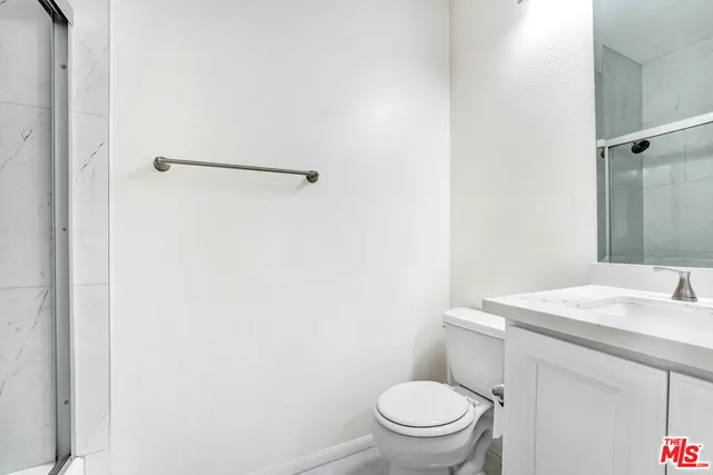 a white toilet sitting next to a bathroom sink