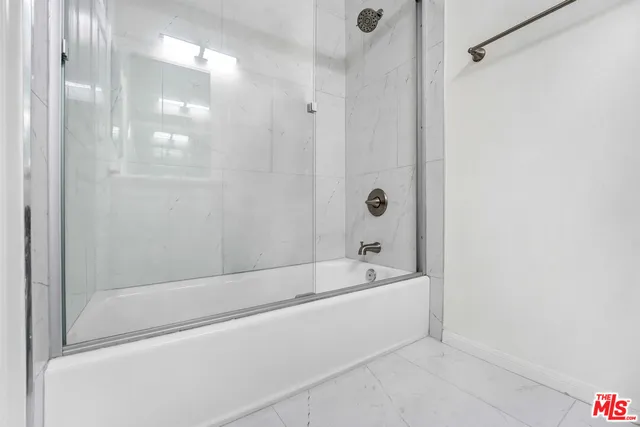 a bathroom with a bathtub and shower