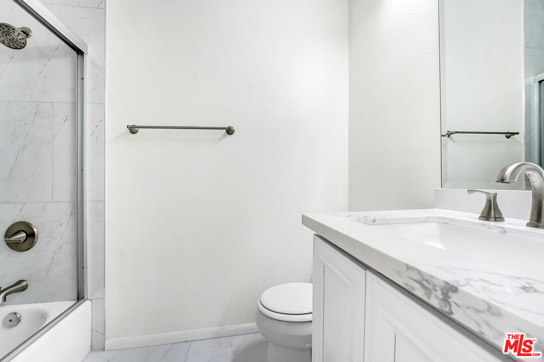 5430 Bellingham Avenue, Unit 306 Valley Village, CA 91607 - Photo 17 of 23 a bathroom with a granite countertop sink toilet and shower