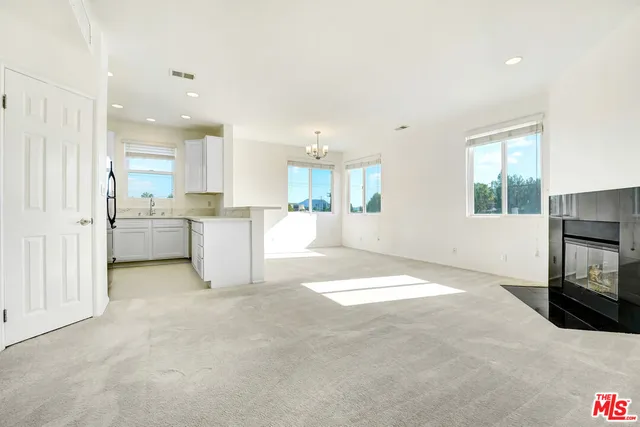 a view of a kitchen with a sink a microwave and cabinets