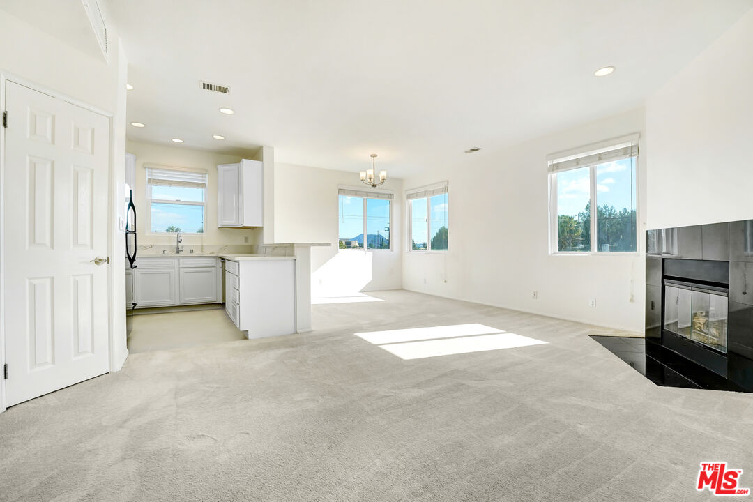 5430 Bellingham Avenue, Unit 306 Valley Village, CA 91607 - Photo 2 of 23 a view of a kitchen with a sink a microwave and cabinets