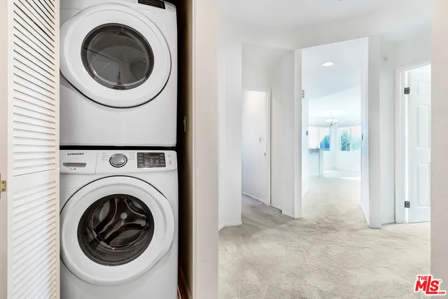 a view of a hallway with washer and dryer