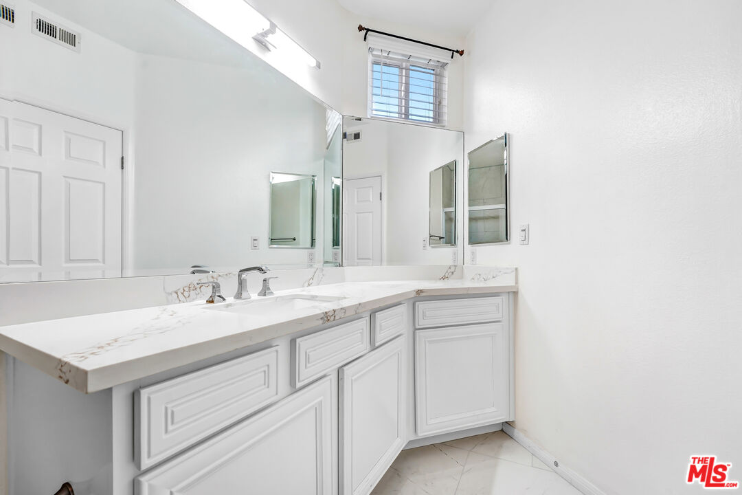 5430 Bellingham Avenue, Unit 306 Valley Village, CA 91607 - Photo 10 of 23 a bathroom with a sink and a mirror