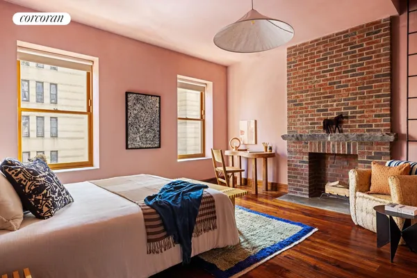 a bedroom with a bed wooden floor and window