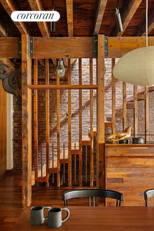 a view of a living room with furniture and floor to ceiling window