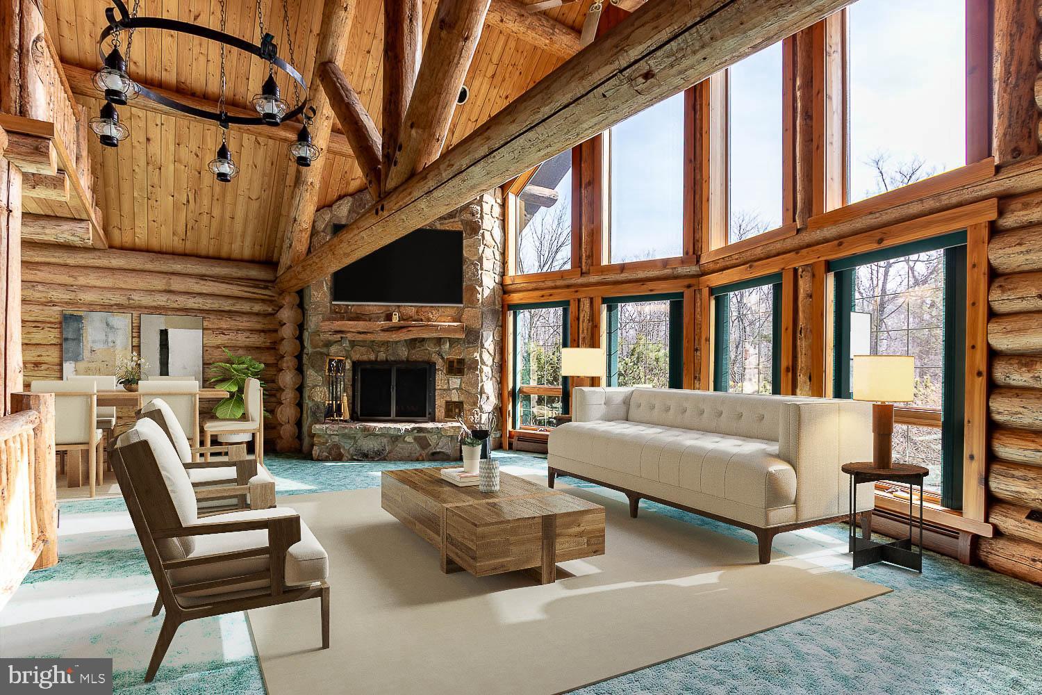 a living room with furniture a fireplace and a large window
