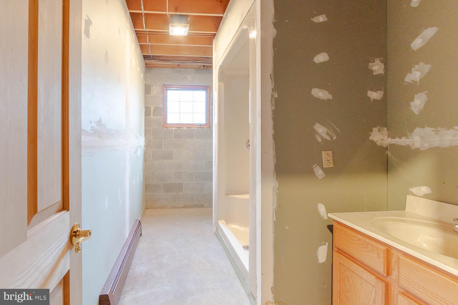 7869 Drane Highway West Decatur, PA 16878 - Photo 34 of 66 a bathroom with a granite countertop sink a mirror and a shower