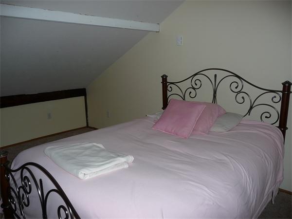 38 Greenwich Plains Road Ware, MA 01082 - Photo 14 of 21 a bedroom with a bed and a black gate
