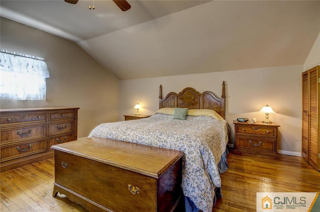 209 North Hill Road Colonia, NJ 07067 - Photo 13 of 18 a bedroom with a bed and a dresser