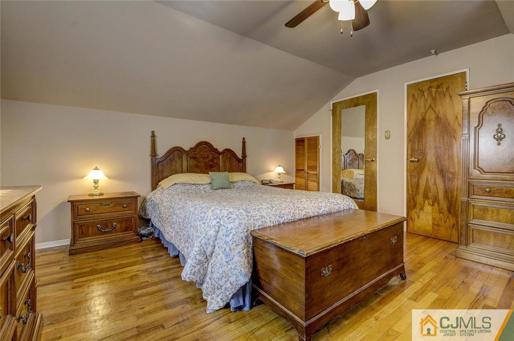 209 North Hill Road Colonia, NJ 07067 - Photo 14 of 18 a bedroom with a bed and wooden floor