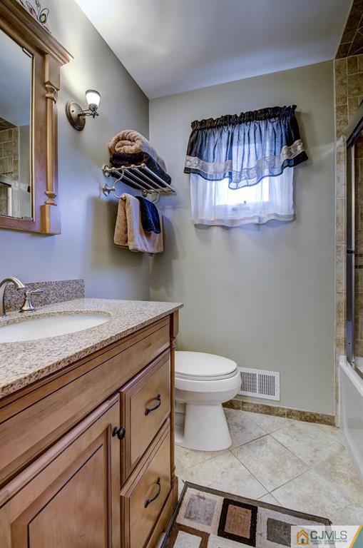 209 North Hill Road Colonia, NJ 07067 - Photo 15 of 18 a bathroom with a sink and a mirror