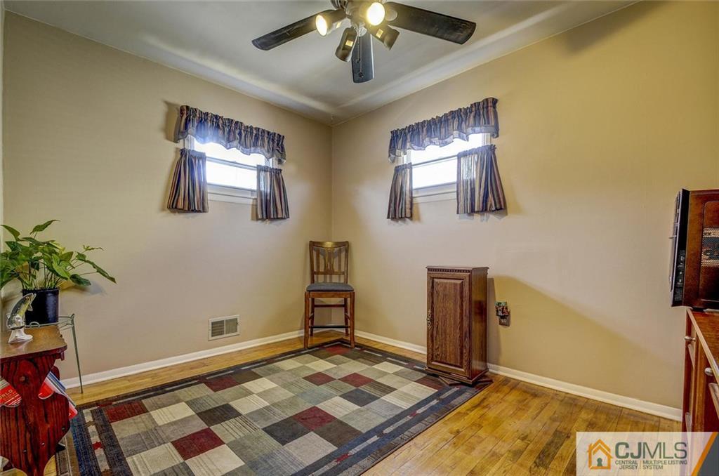 209 North Hill Road Colonia, NJ 07067 - Photo 16 of 18 a living room with a flat screen tv and a potted plant
