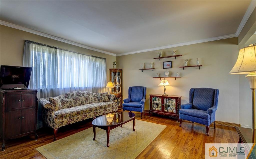209 North Hill Road Colonia, NJ 07067 - Photo 5 of 18 a living room with furniture and a flat screen tv