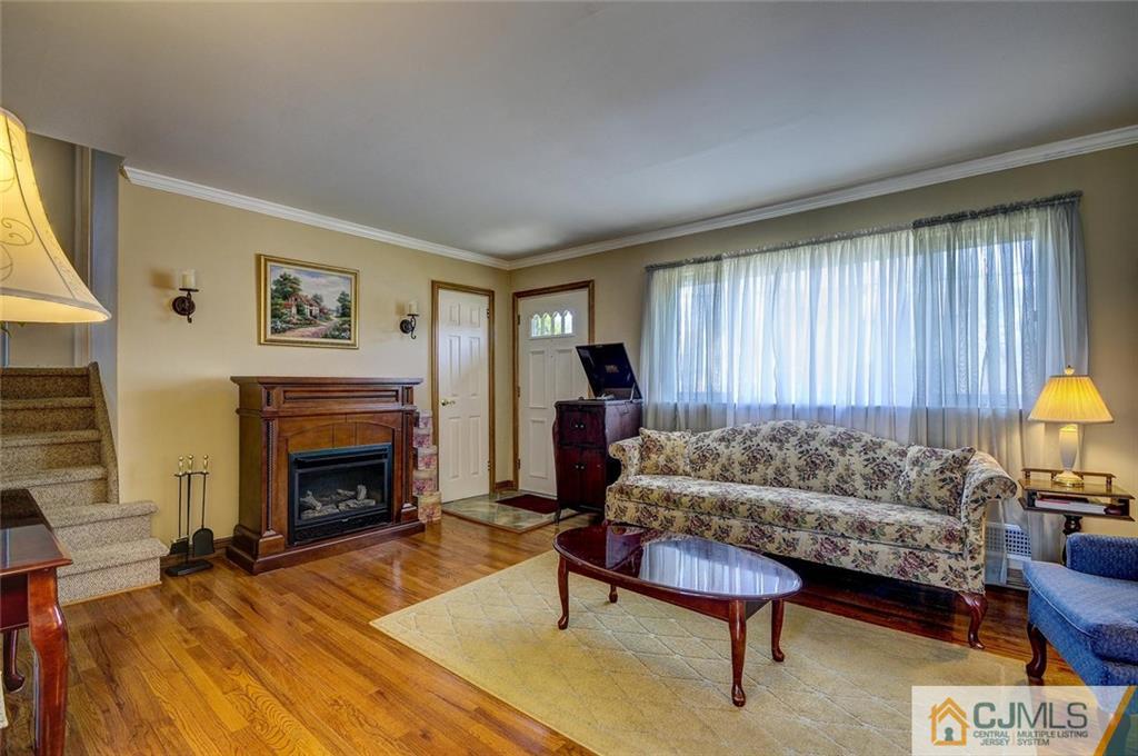 209 North Hill Road Colonia, NJ 07067 - Photo 6 of 18 a living room with furniture and a fireplace