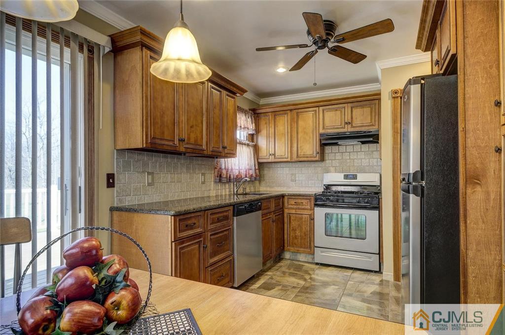 209 North Hill Road Colonia, NJ 07067 - Photo 7 of 18 a kitchen with stainless steel appliances granite countertop a stove a sink dishwasher and a refrigerator with wooden floor