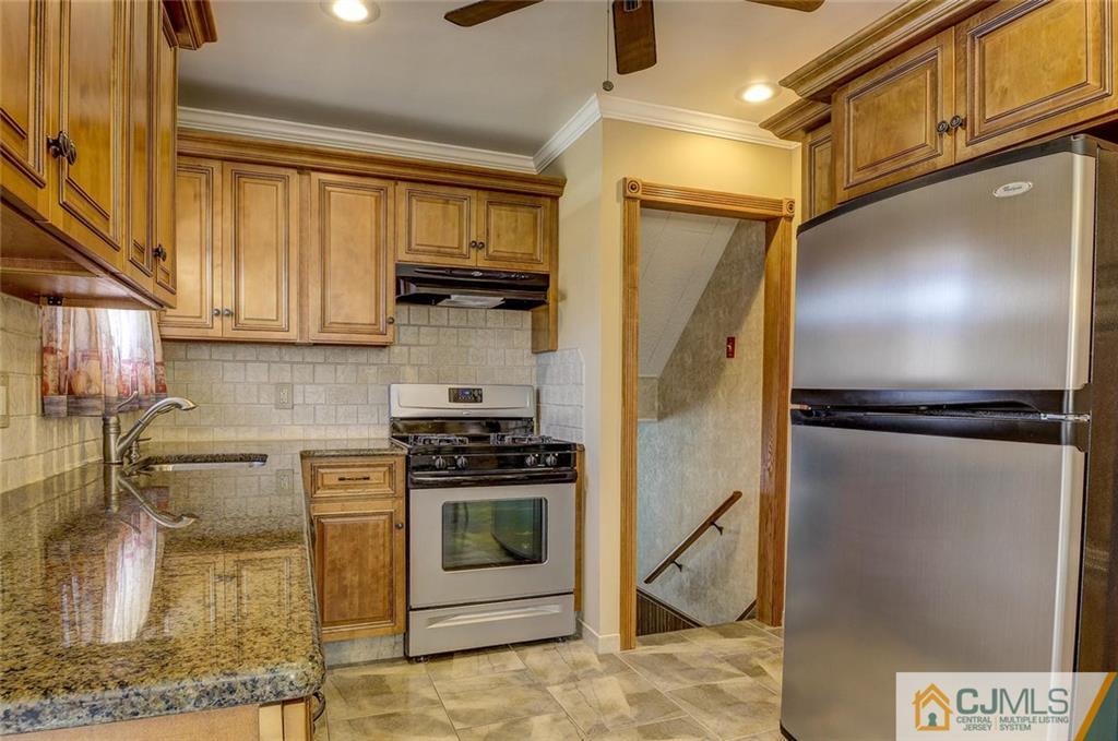 209 North Hill Road Colonia, NJ 07067 - Photo 9 of 18 a kitchen with a refrigerator a stove and a sink