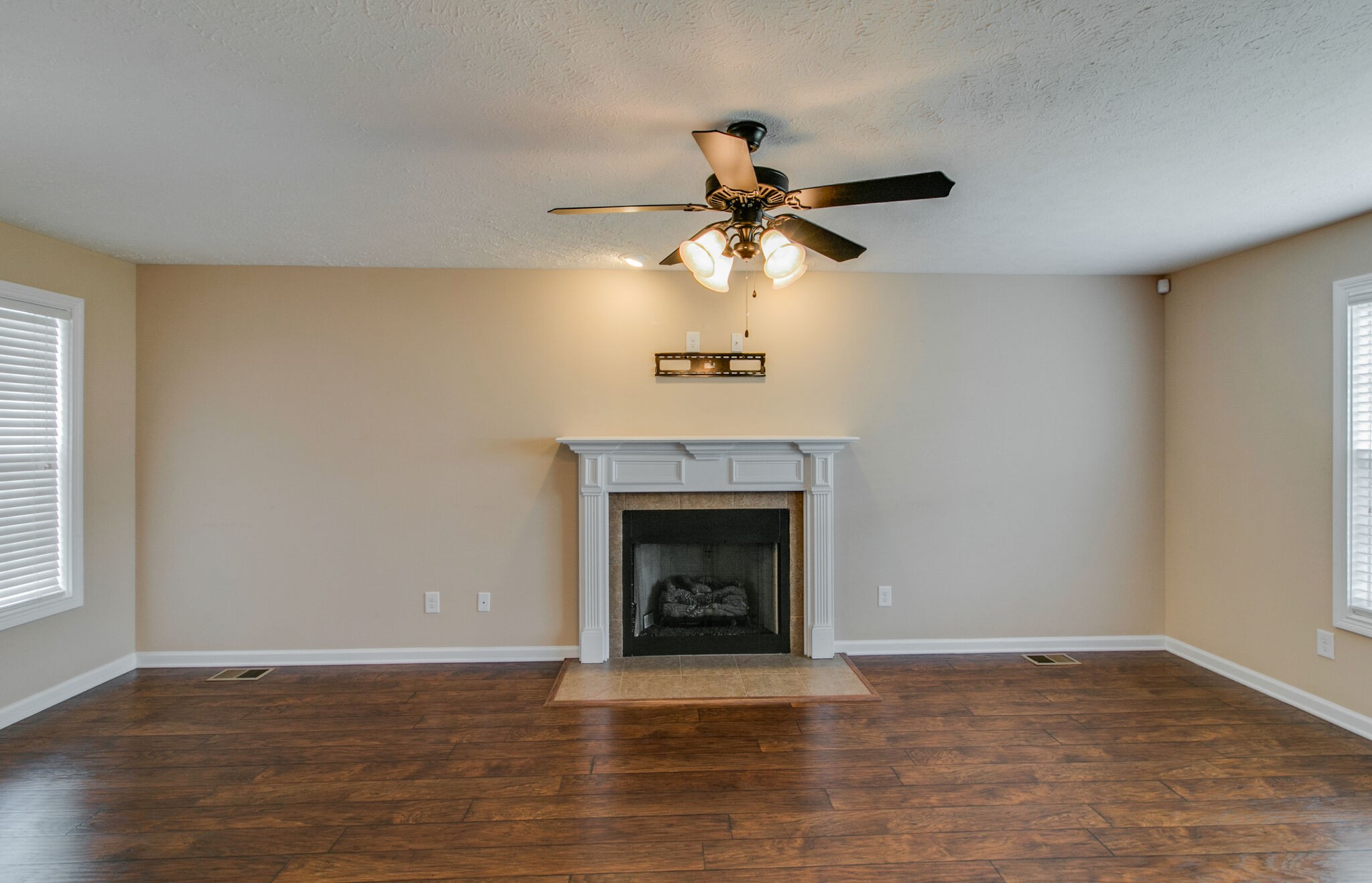 3744 Suiter Road Clarksville, TN 37040 - Photo 7 of 26 a view of an empty room with wooden floor and a fireplace