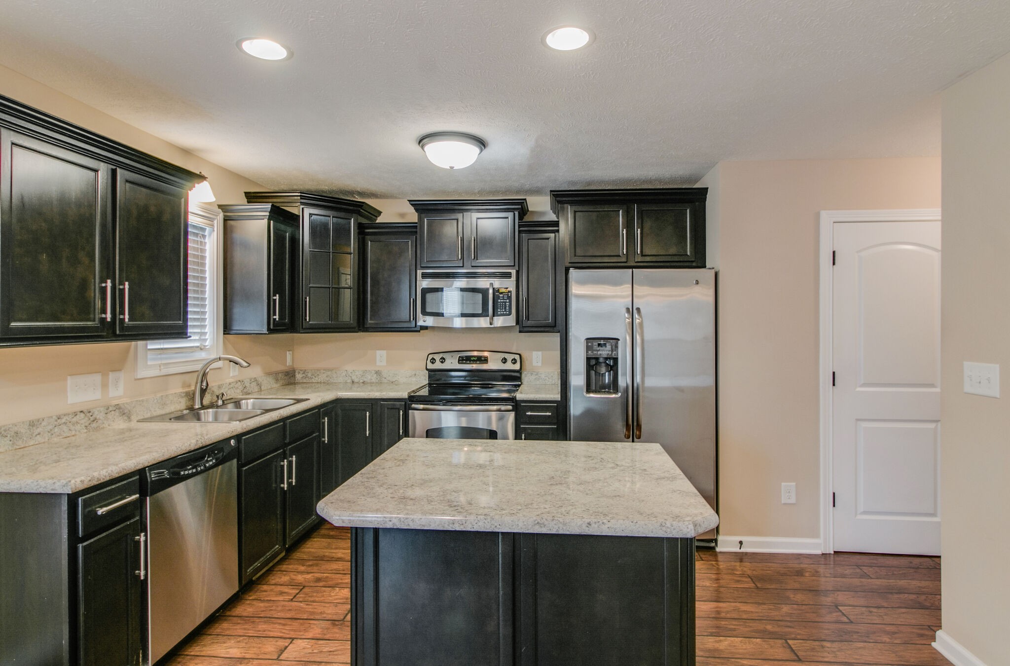 3744 Suiter Road Clarksville, TN 37040 - Photo 10 of 26 a kitchen with a sink a counter top space cabinets and stainless steel appliances
