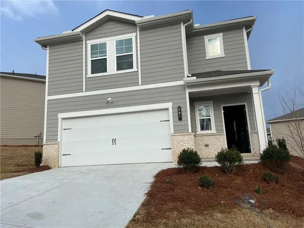 a front view of a house with a yard and garage