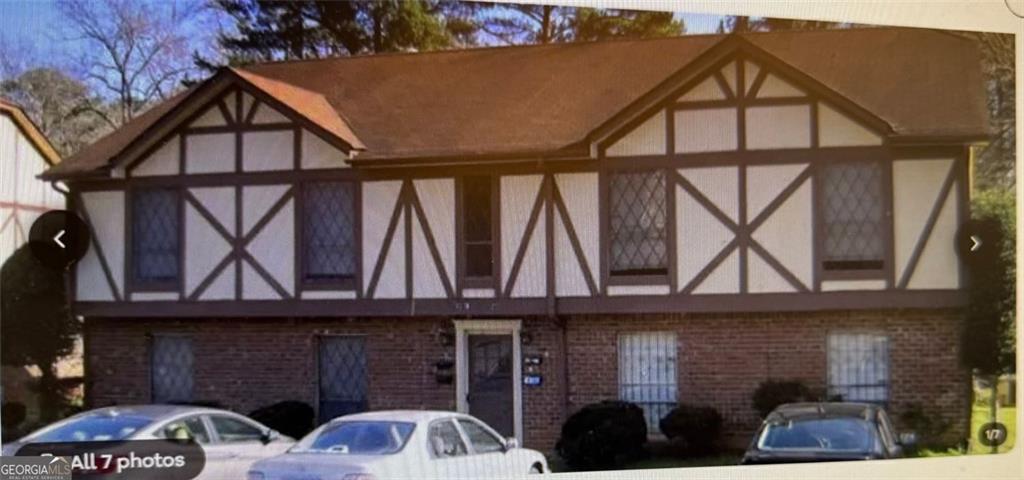 a front view of a house with parking area