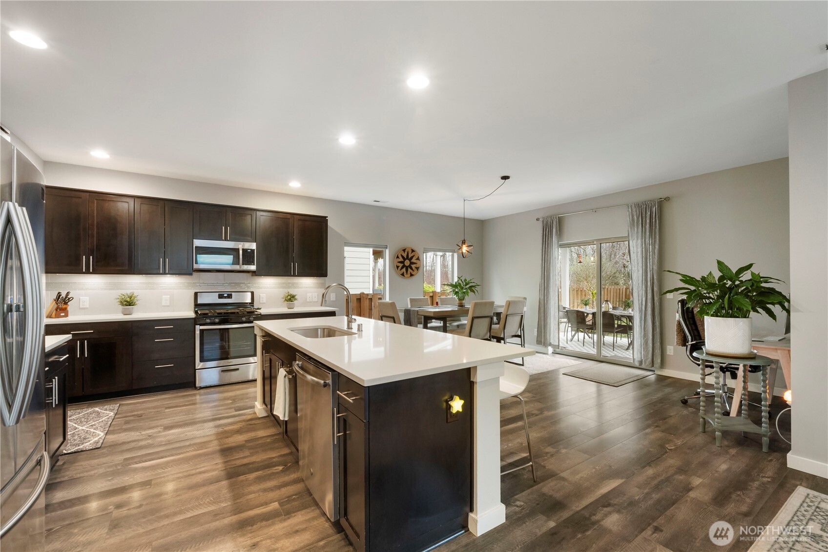 329 South Spruce Street Buckley, WA 98321 - Photo 11 of 36 a large kitchen with a large counter top space a sink stainless steel appliances and cabinets