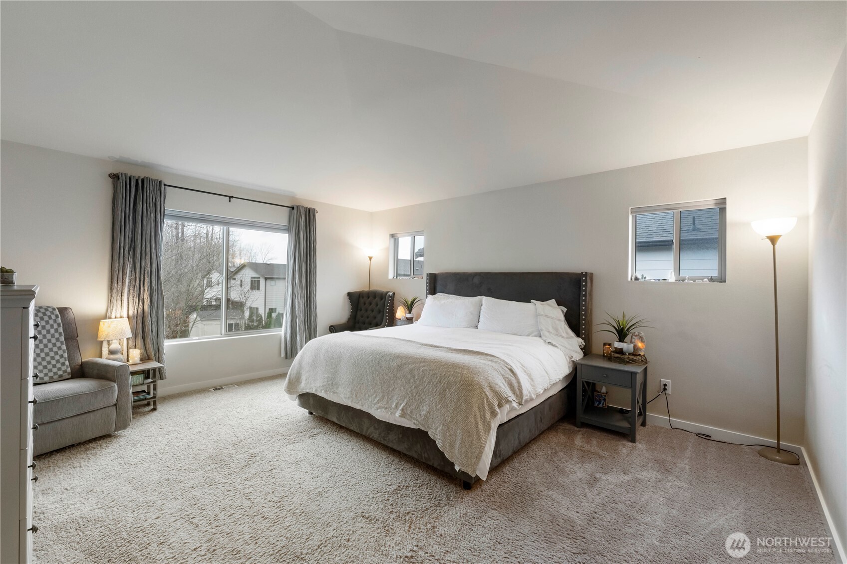 329 South Spruce Street Buckley, WA 98321 - Photo 18 of 36 a spacious bedroom with a bed and a couch