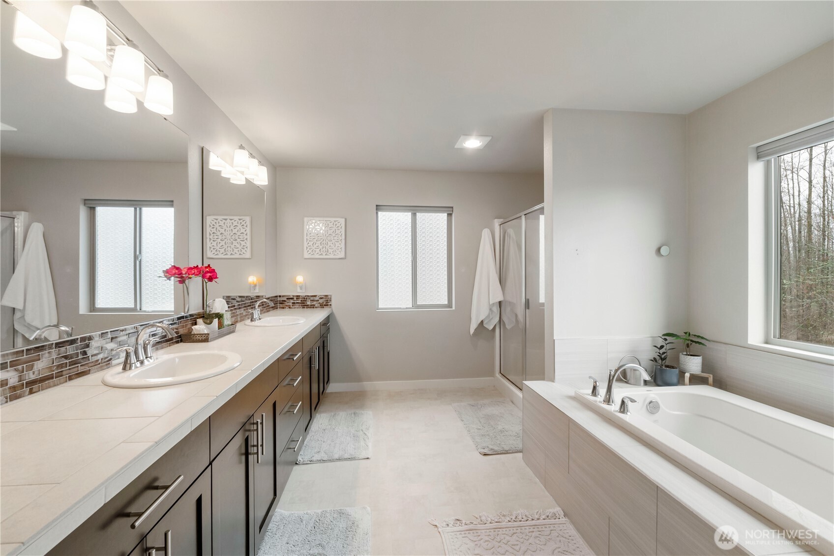 329 South Spruce Street Buckley, WA 98321 - Photo 21 of 36 a spacious bathroom with a bathtub sink and mirror